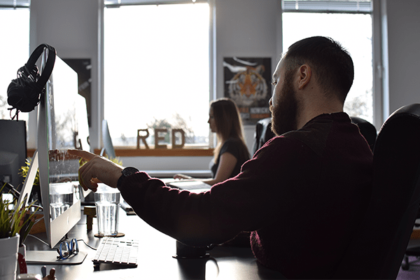 Whitespacepw: Sales Executive job advert with a red and purple gradient background and Whitespacepw logo and a faded background of a person looking at a screen